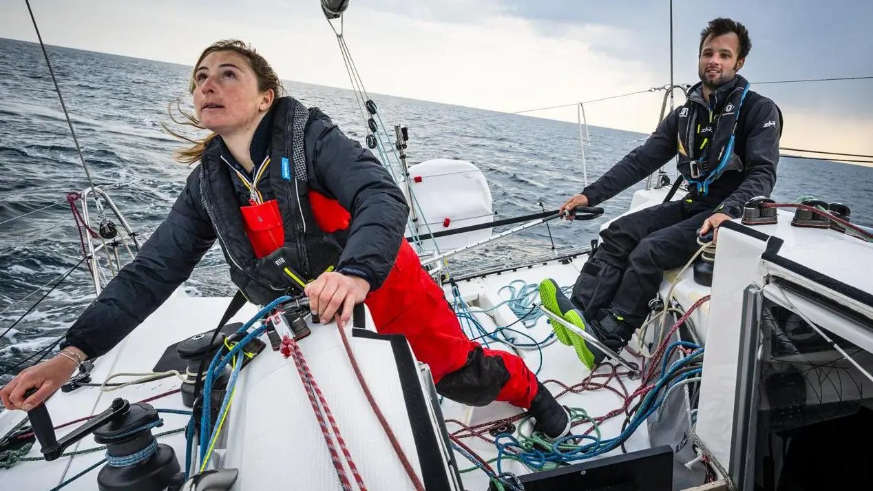 Sailing crew in a monohull doing a yacht delivery